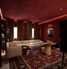 Explore this richly layered lounge by HAUS Living — a bold interior featuring Persian rugs, sculptural furniture, and warm moody walls. For creatives and cultural rebels.