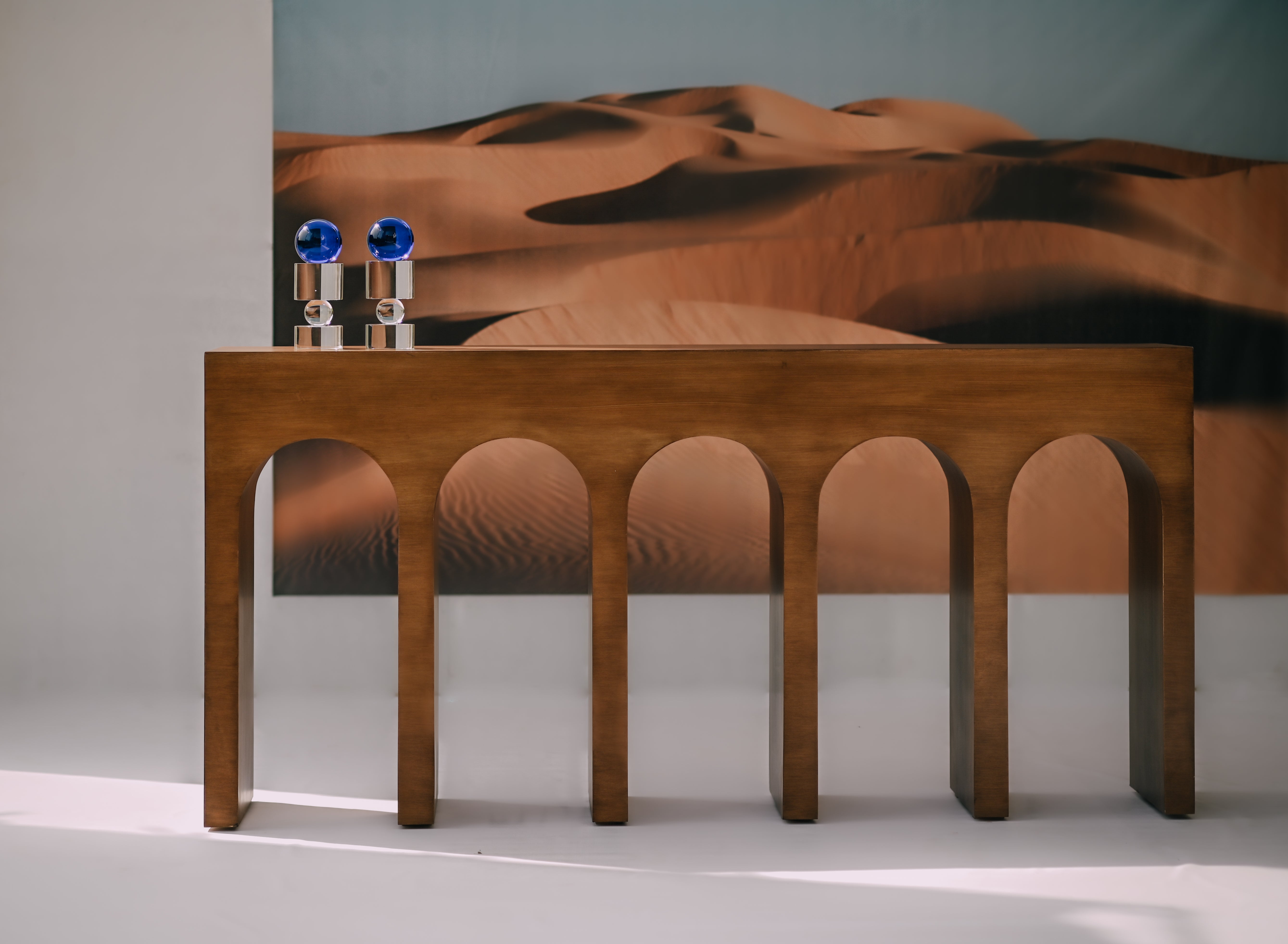 DOMUS Console - Modern Arched Wooden Console Table set against a cinematic desert backdrop by Ali Khan Studio Karachi Pakistan