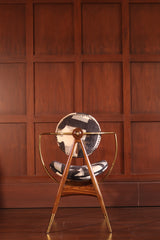 HALO Dining Chair - Sculptural brass and wood chair with patterned upholstery in a luxury wood-paneled room by Ali Khan Studio