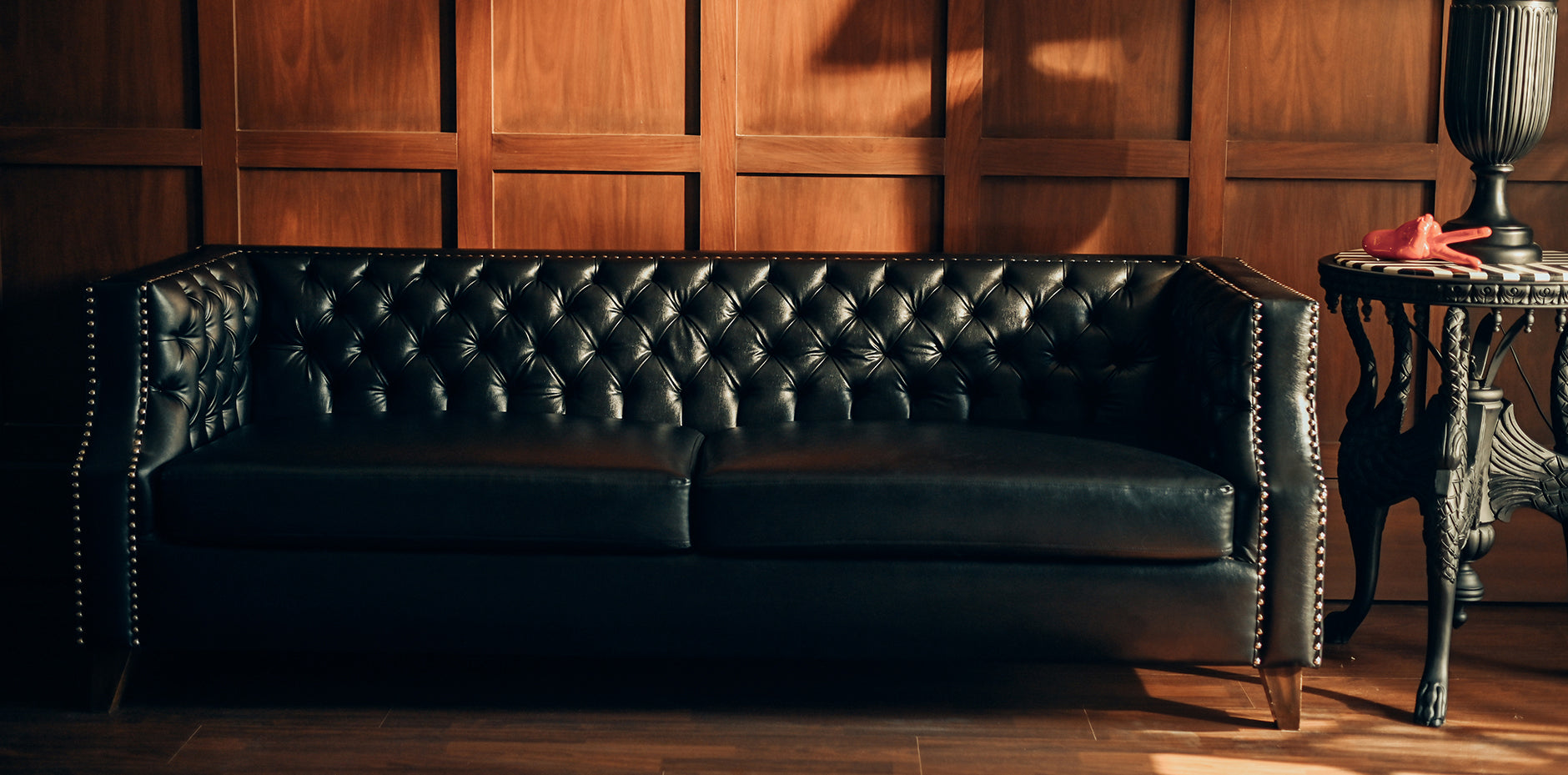 Close-up of the deep button tufting and classic rolled arms on the NOIR Chesterfield Sofa
