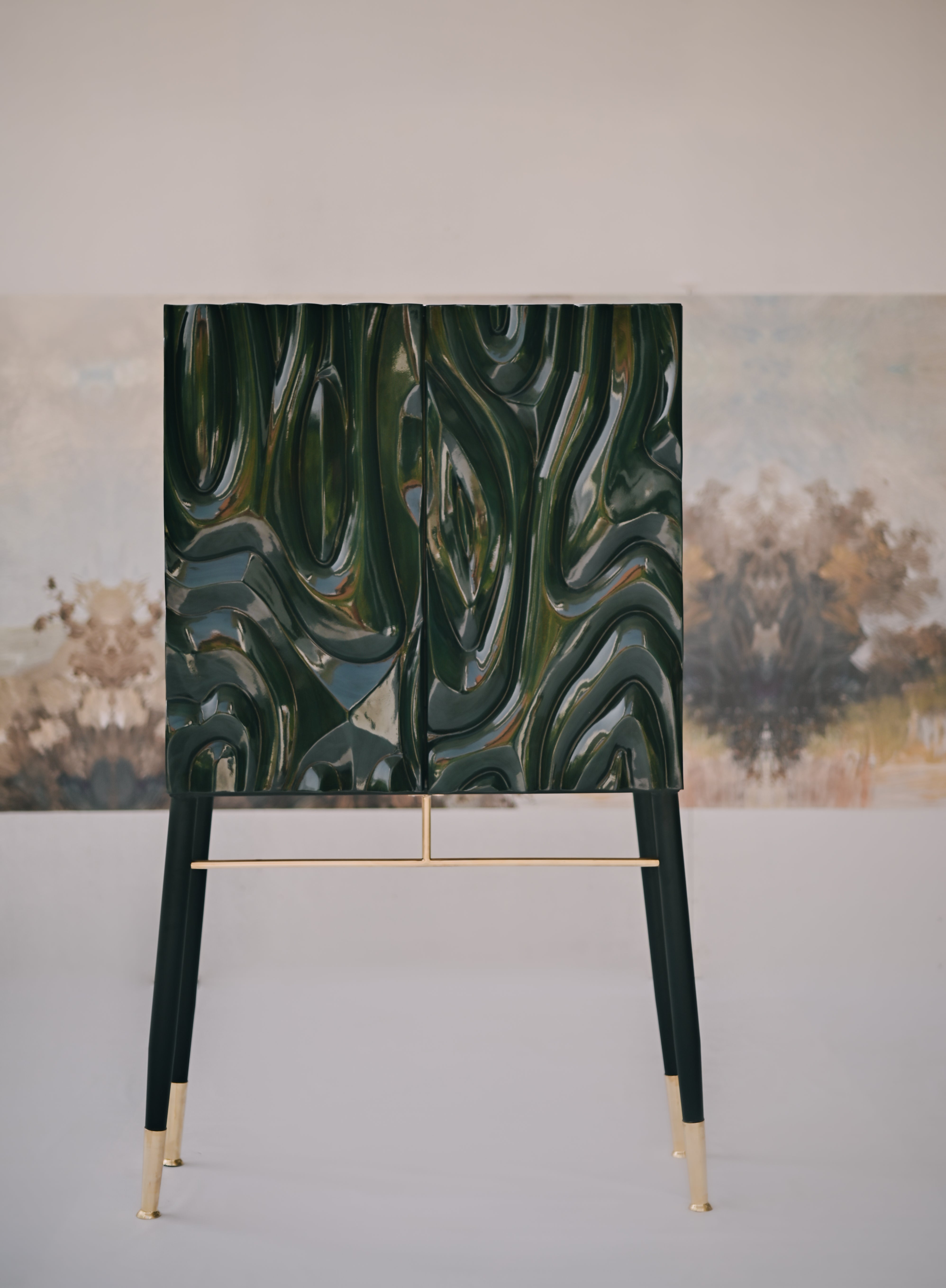 Intricate relief carving on a charcoal-stained furniture facade by Ali Khan Studio, showcasing modern organic patterns and intelligent detailing.