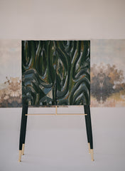 Intricate relief carving on a charcoal-stained furniture facade by Ali Khan Studio, showcasing modern organic patterns and intelligent detailing.