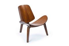 Side profile of the SHELL Chair showing its fluid organic wooden curves and floating silhouette