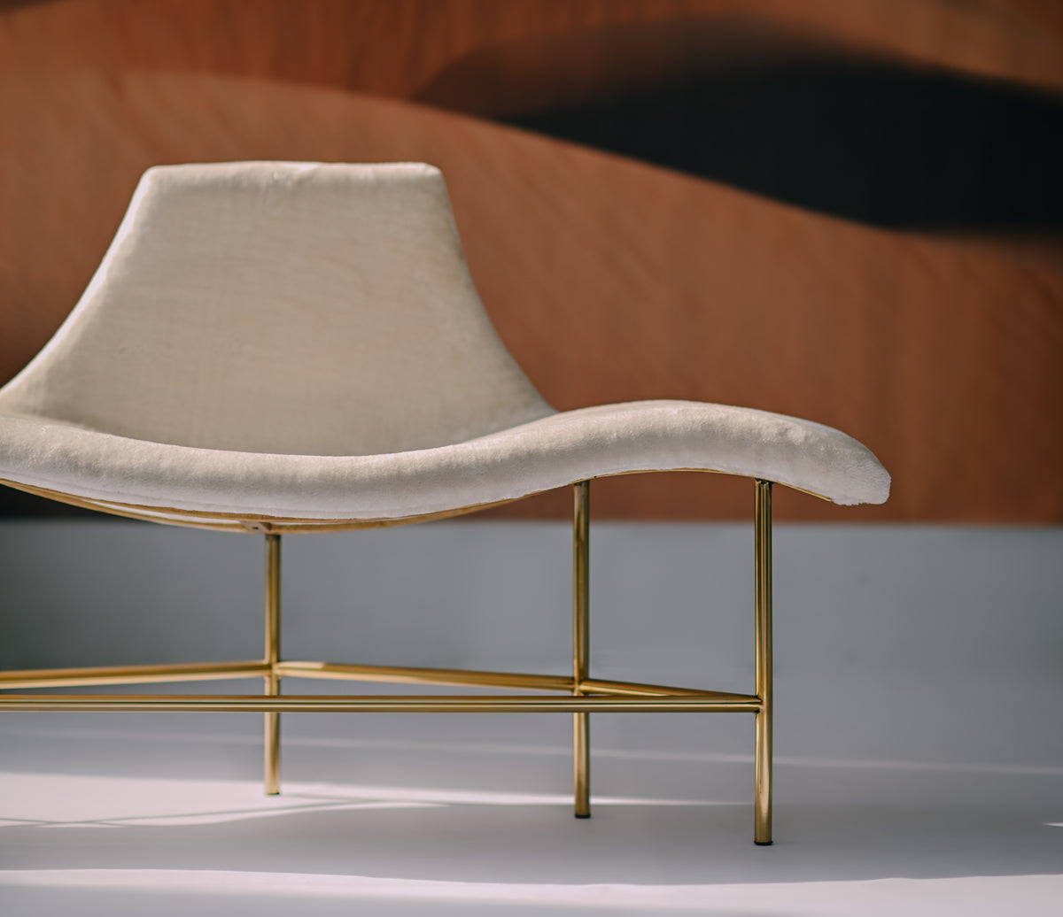 The Verona Chaise - A glamorous white statement chair with gold legs by Ali Khan Studio